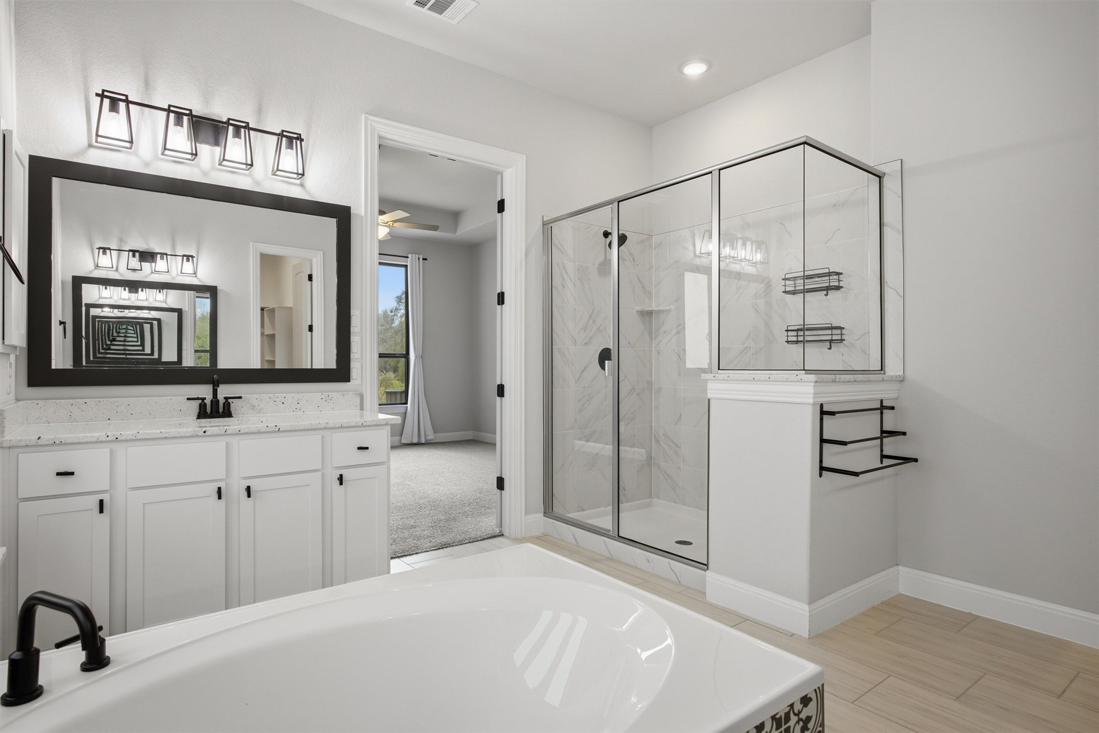 208 Tovas Secret Cove Georgetown, TX 78628 - Photo 19 of 40 a spacious bathroom with a shower a sink and a mirror