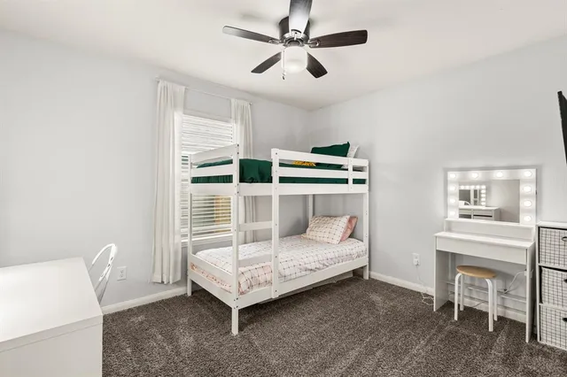 a bedroom with a bed and a table in it