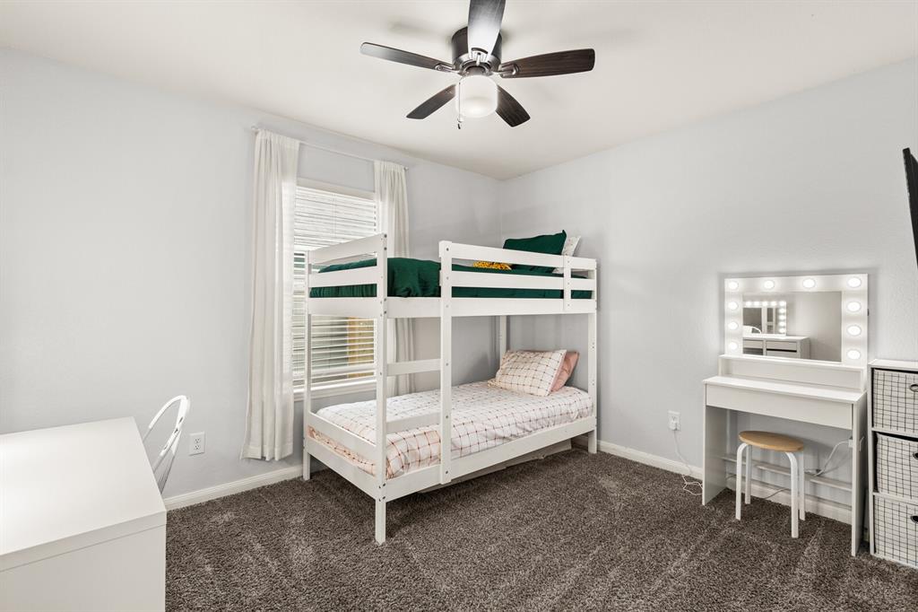 10237 Omni Drive Waco, TX 76708 - Photo 11 of 40 a bedroom with a bed and a table in it