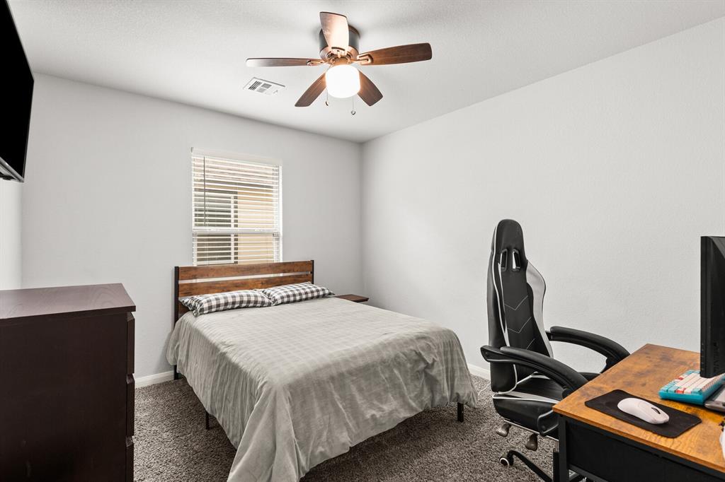 10237 Omni Drive Waco, TX 76708 - Photo 15 of 40 a bedroom with a bed and a desk