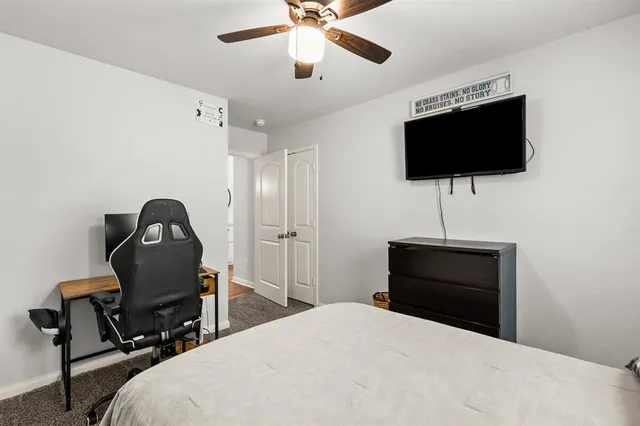 a living room with couches a flat screen tv and kitchen view
