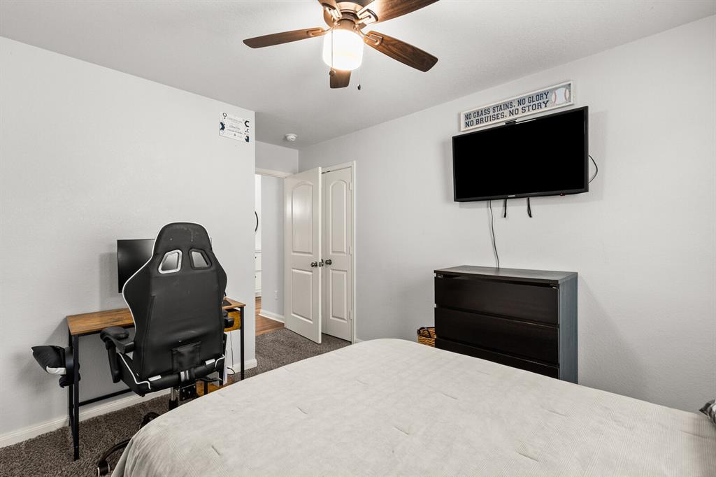 10237 Omni Drive Waco, TX 76708 - Photo 16 of 40 a bedroom with a bed and a flat screen tv
