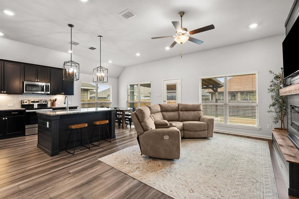 10237 Omni Drive Waco, TX 76708 - Photo 18 of 40 a living room with couches a flat screen tv and kitchen view