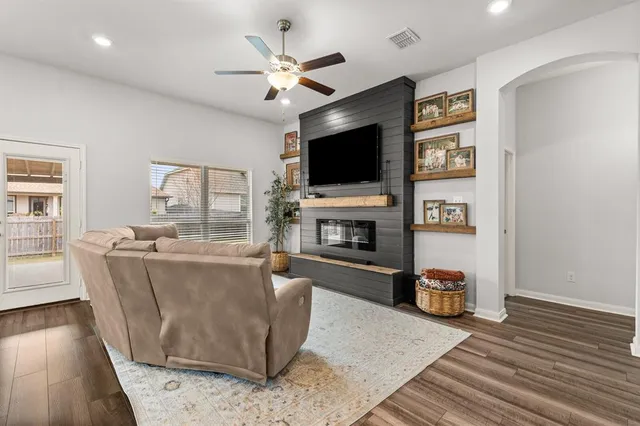 a kitchen with stainless steel appliances granite countertop a sink a stove a refrigerator cabinets and chairs