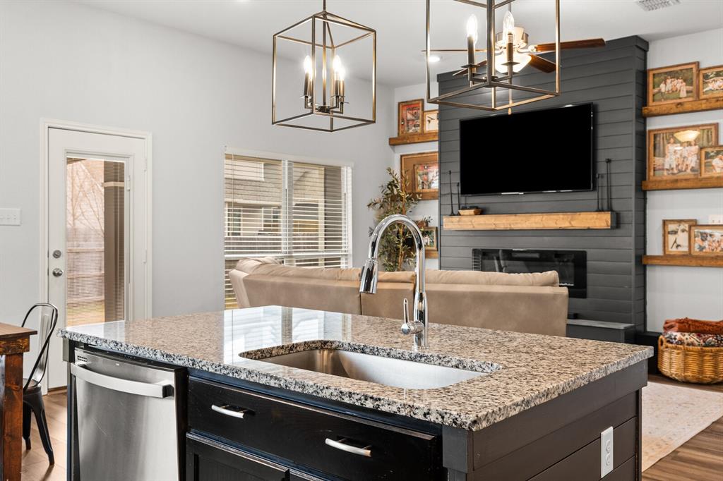 10237 Omni Drive Waco, TX 76708 - Photo 25 of 40 a kitchen with granite countertop a sink and a microwave