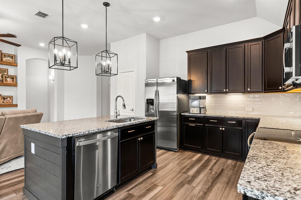 10237 Omni Drive Waco, TX 76708 - Photo 26 of 40 a kitchen with stainless steel appliances granite countertop a sink stove and refrigerator