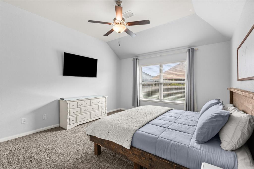 10237 Omni Drive Waco, TX 76708 - Photo 33 of 40 a bedroom with a large bed and a flat screen tv