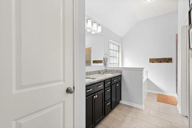 a bathroom with a tub and a window