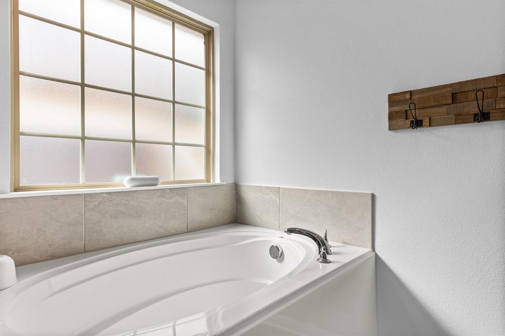10237 Omni Drive Waco, TX 76708 - Photo 36 of 40 a bathroom with a tub and a window