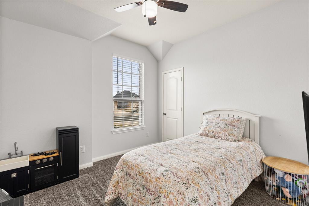 10237 Omni Drive Waco, TX 76708 - Photo 8 of 40 a bedroom with a bed and a chandelier