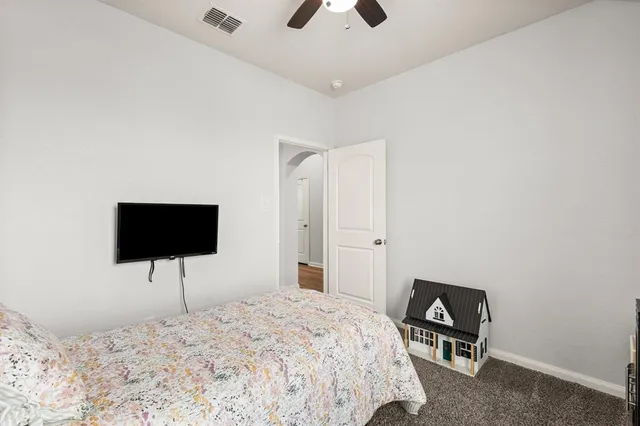 a bedroom with a bed and a flat screen tv
