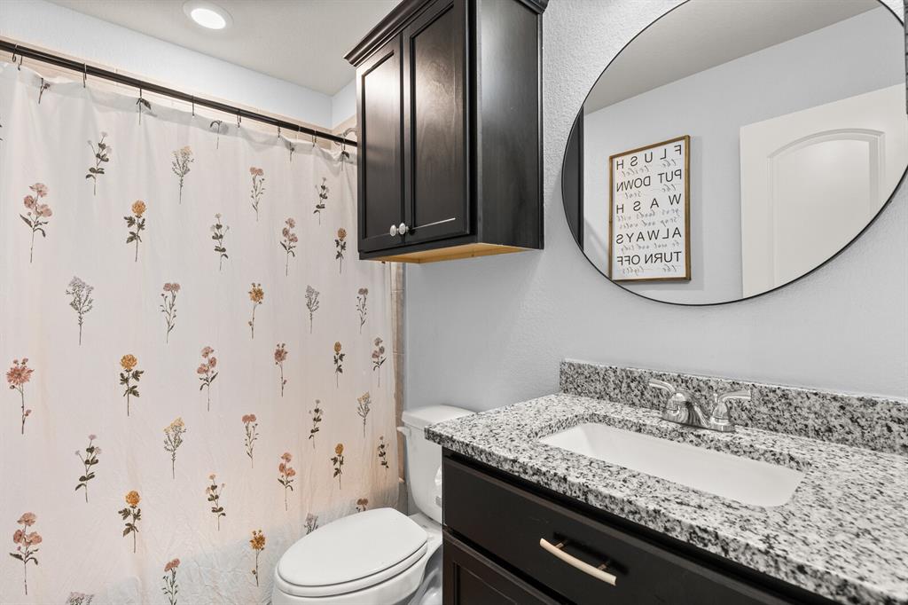 10237 Omni Drive Waco, TX 76708 - Photo 10 of 40 a bathroom with a granite countertop sink and a mirror