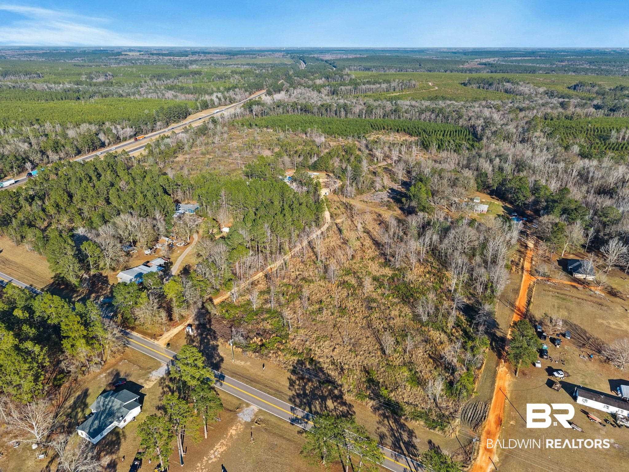55750 Lottie Road Perdido, AL 36562 - Photo 11 of 84 Aerial view of property and surrounding area with a forest and rural landscape