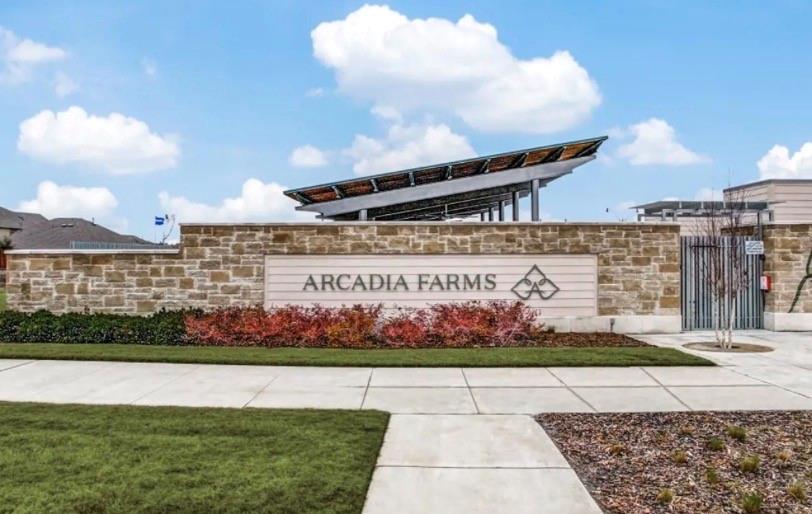 406 Madrone Lane Princeton, TX 75407 - Photo 27 of 30 Stone and stucco community entrance signage featuring "Arcadia Farms," structured landscaping, and a side gate