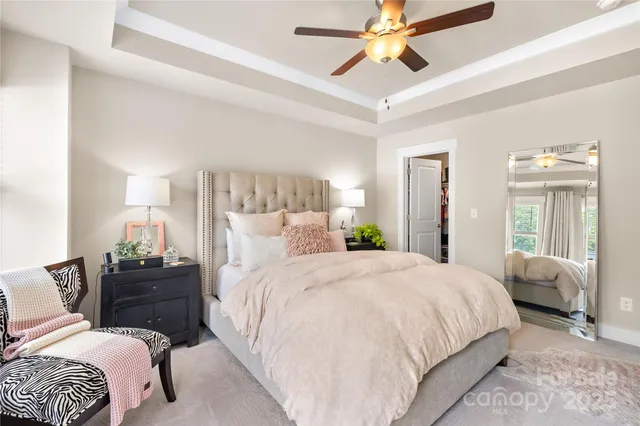 a bedroom with a bed and ceiling fan
