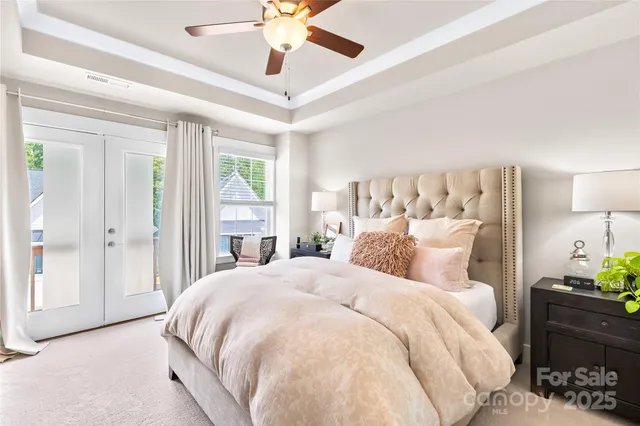 a bed room with a bed and a chandelier