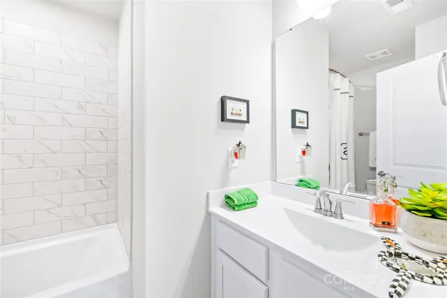 a bathroom with a sink a vanity and a bathtub