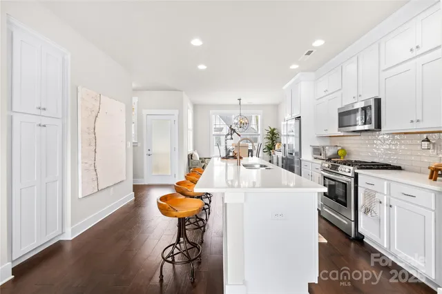 a kitchen with a sink appliances and cabinets