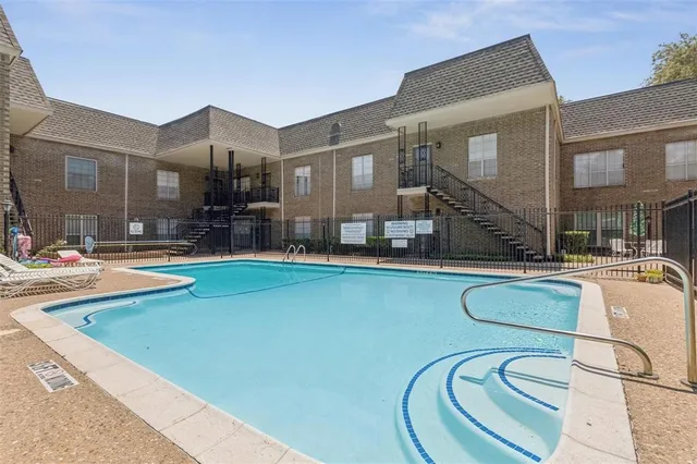 a swimming pool with outdoor seating and yard