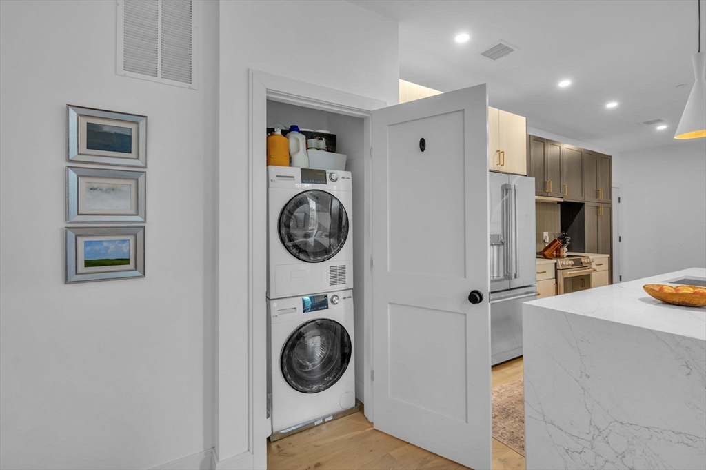 5245 Washington Street, Unit 5 Boston, MA 02132 - Photo 16 of 37 a view of a hallway with washer and dryer