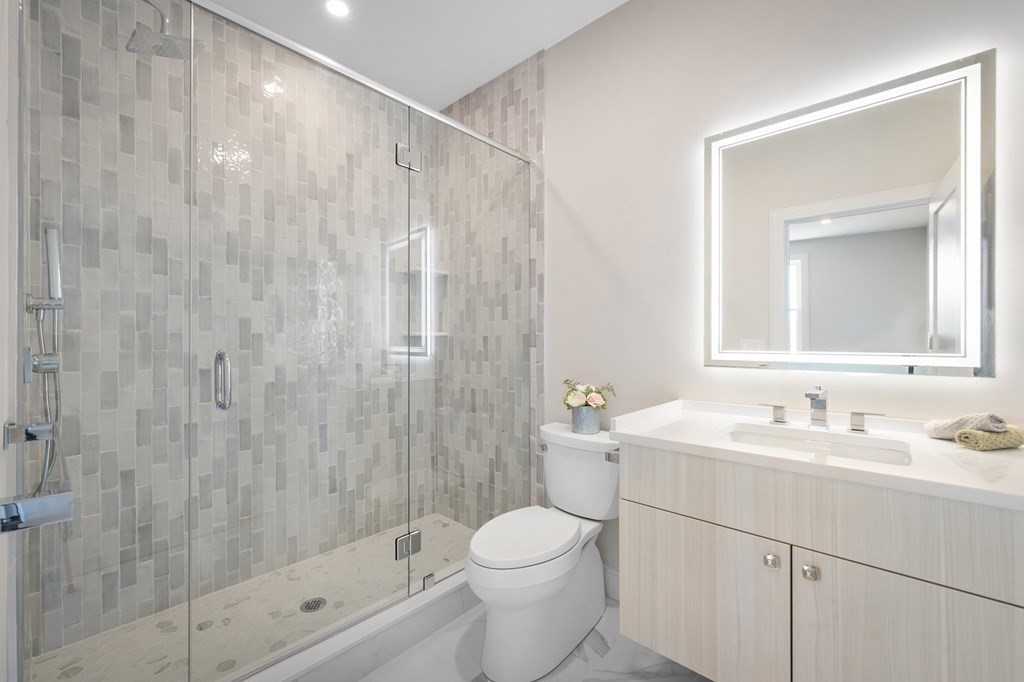 5245 Washington Street, Unit 5 Boston, MA 02132 - Photo 19 of 37 a bathroom with a sink toilet and shower