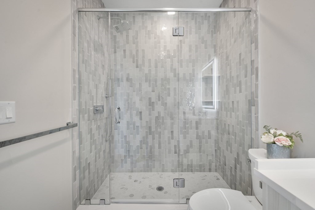 5245 Washington Street, Unit 5 Boston, MA 02132 - Photo 20 of 37 a bathroom with a shower curtain and a sink