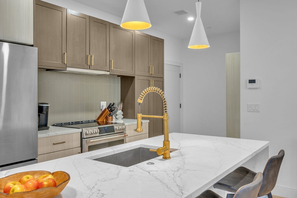 5245 Washington Street, Unit 5 Boston, MA 02132 - Photo 2 of 37 a kitchen with granite countertop a sink cabinets and appliances