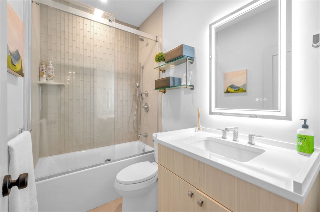 5245 Washington Street, Unit 5 Boston, MA 02132 - Photo 24 of 37 a bathroom with a sink a toilet and shower