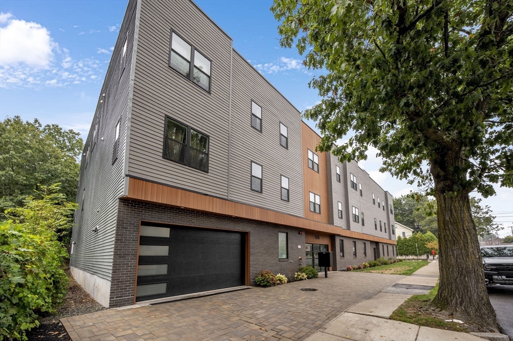 5245 Washington Street, Unit 5 Boston, MA 02132 - Photo 26 of 37 a front view of a house with a yard
