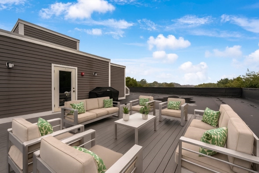 5245 Washington Street, Unit 5 Boston, MA 02132 - Photo 30 of 37 a view of a roof deck with couches