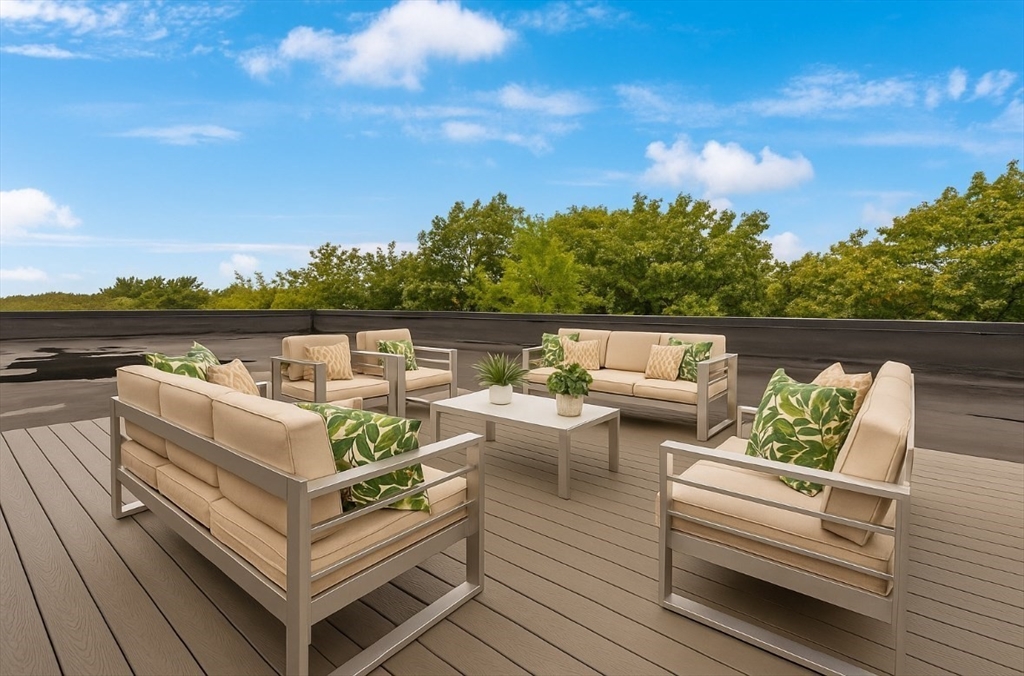 5245 Washington Street, Unit 5 Boston, MA 02132 - Photo 31 of 37 a view of a roof deck with couches and wooden floor