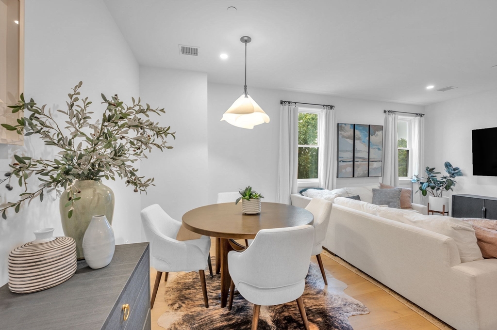 5245 Washington Street, Unit 5 Boston, MA 02132 - Photo 8 of 37 a dining room with furniture a chandelier and window