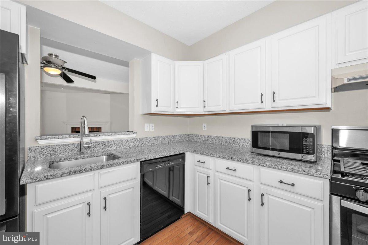 1184 Heathfield Road Sykesville, MD 21784 - Photo 11 of 56 a kitchen with granite countertop white cabinets and a sink