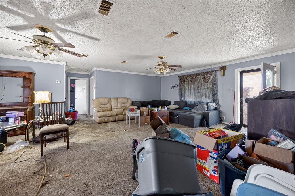 801 North Main Street Dodd City, TX 75438 - Photo 12 of 31 a living room with furniture and a chandelier
