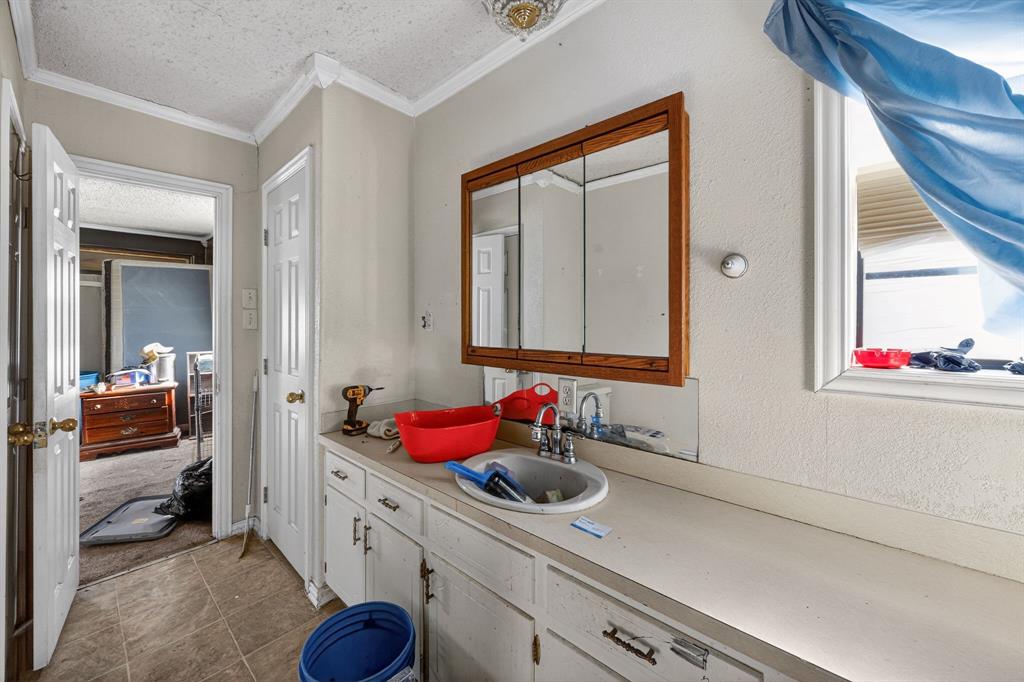 801 North Main Street Dodd City, TX 75438 - Photo 25 of 31 a bathroom with a sink vanity and a mirror