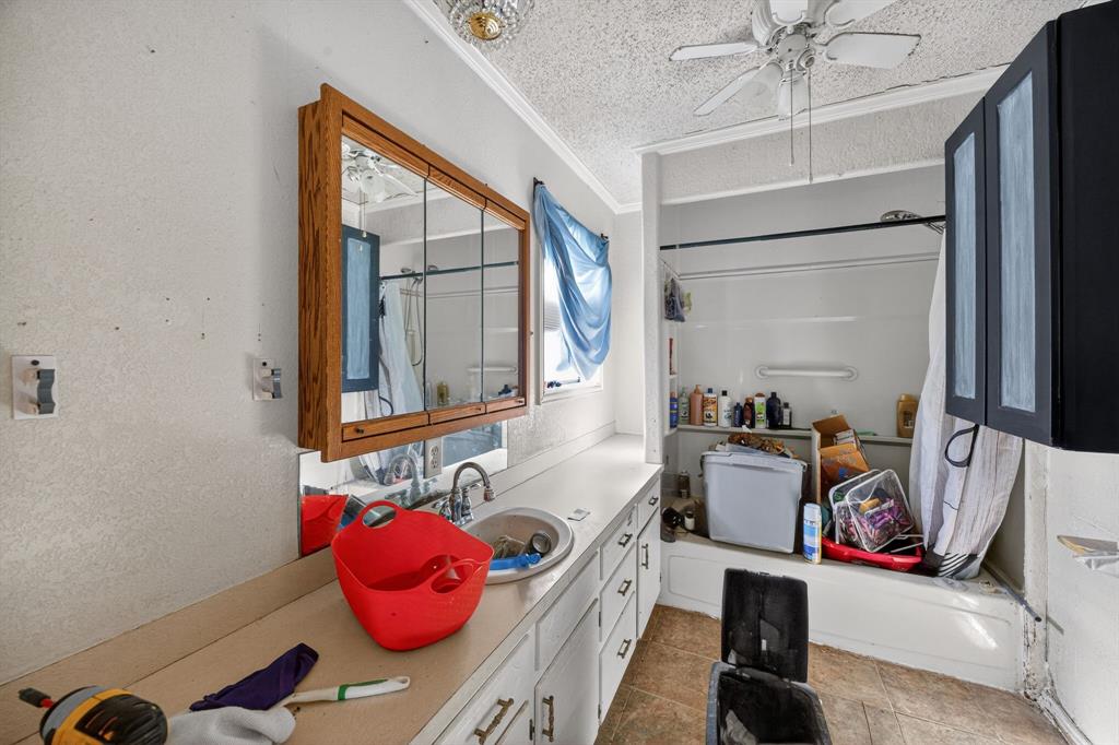 801 North Main Street Dodd City, TX 75438 - Photo 27 of 31 a bedroom with a bed and a chandelier