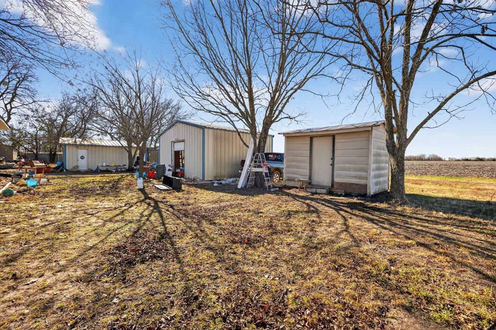 801 North Main Street Dodd City, TX 75438 - Photo 7 of 31 a front view of a house with a yard covered in snow