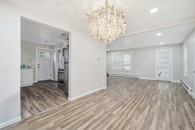 a view of a room with wooden floor and ceiling fan