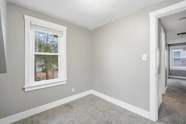 an empty room with windows and closet