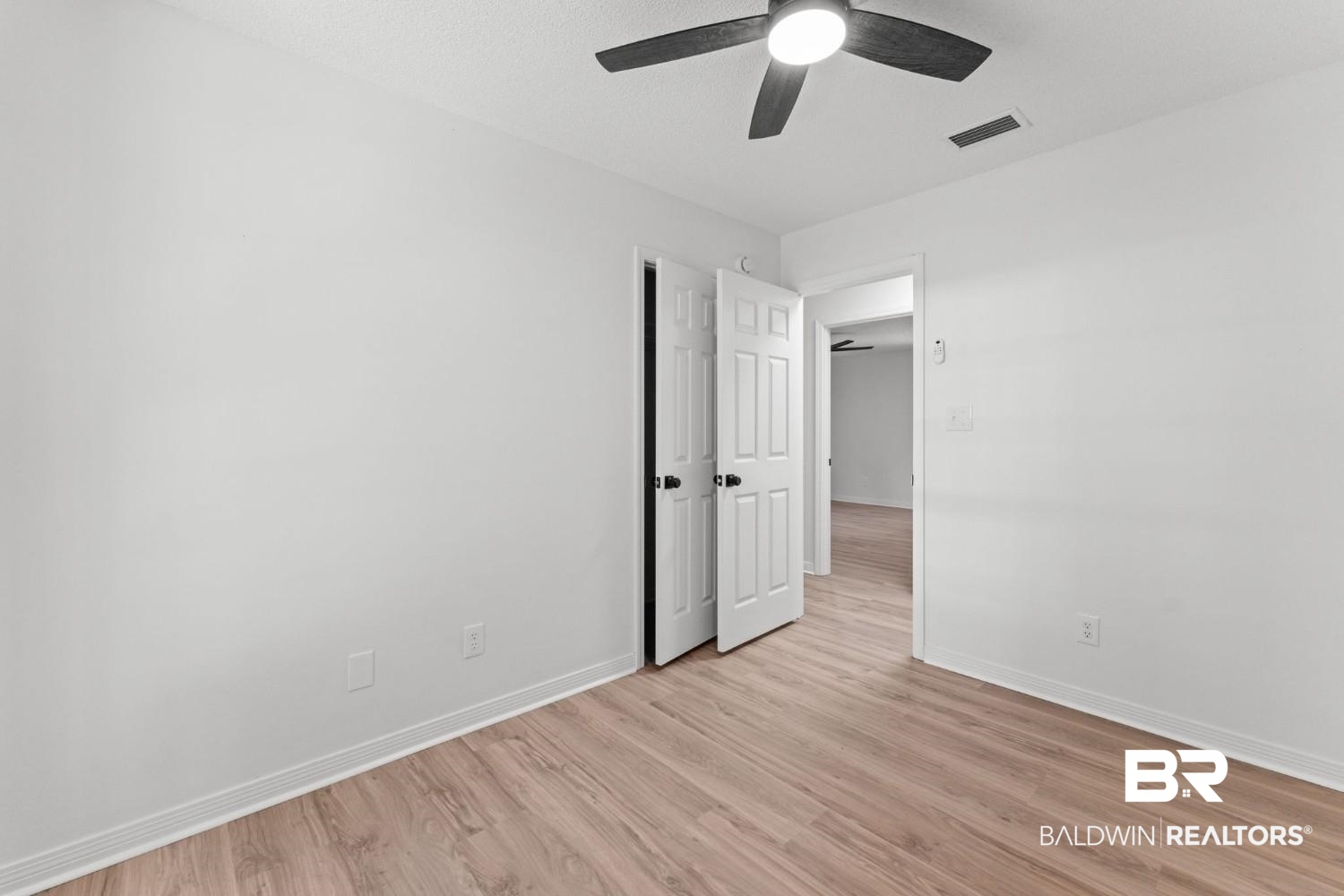 10251 Windmill Road Fairhope, AL 36532 - Photo 31 of 44 Empty room with light wood finished floors and a ceiling fan