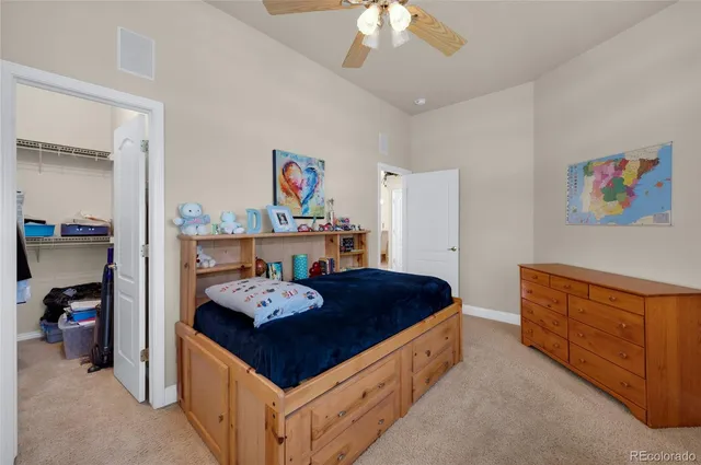 a living room with furniture and a baby crib