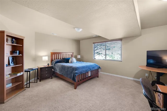 a bedroom with furniture and a flat screen tv