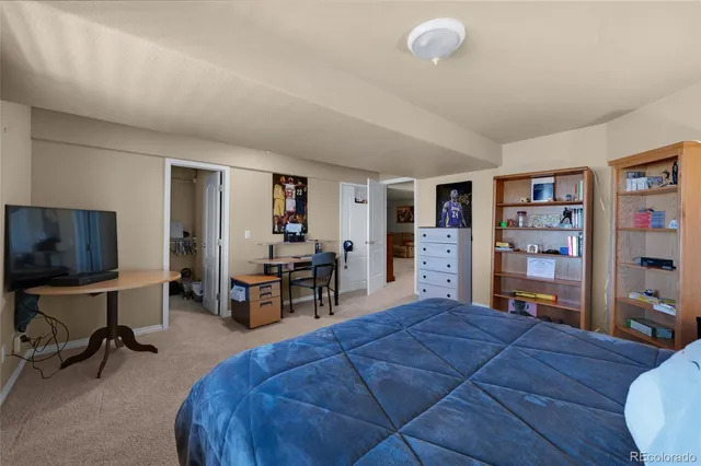 a bed room with a bed window and a chair