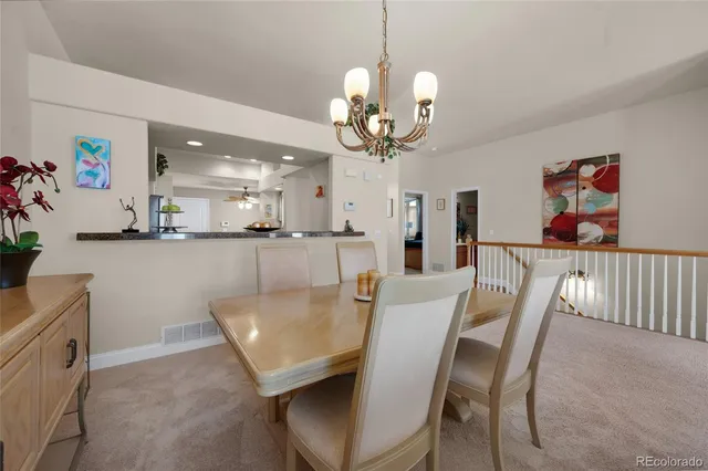 a view of a dining room with furniture and chandelier
