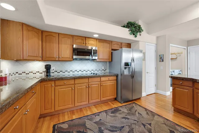 a kitchen with stainless steel appliances granite countertop a refrigerator sink and cabinets