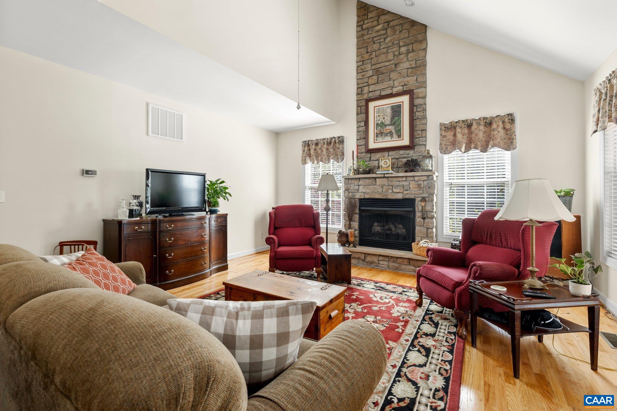 5437 3 Notch Road Louisa, VA 23093 - Photo 15 of 35 a living room with furniture a flat screen tv and a fireplace