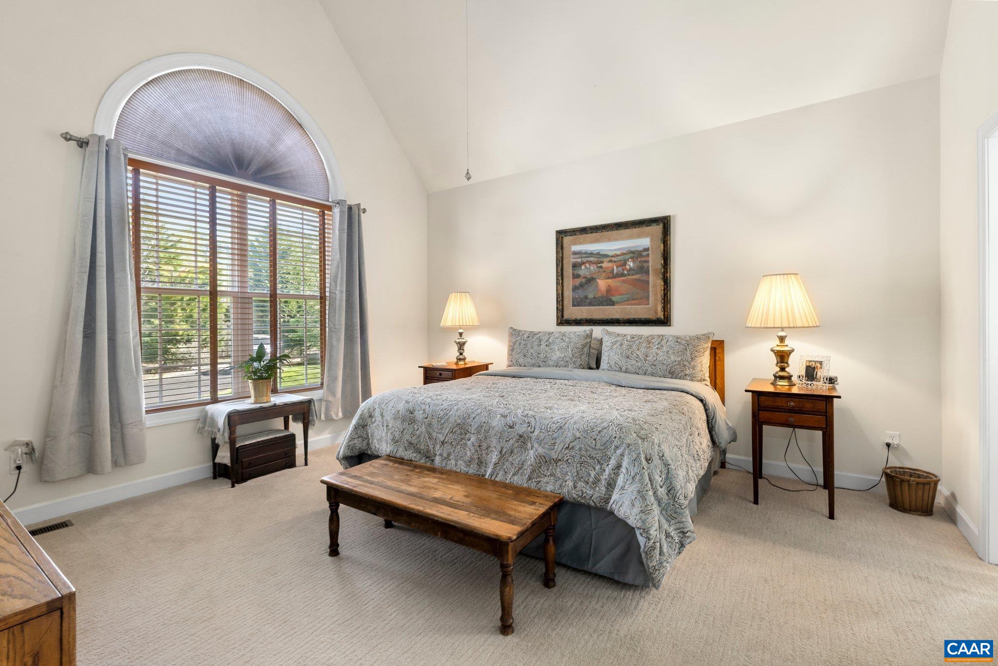 5437 3 Notch Road Louisa, VA 23093 - Photo 20 of 35 a spacious bedroom with a bed and a chandelier