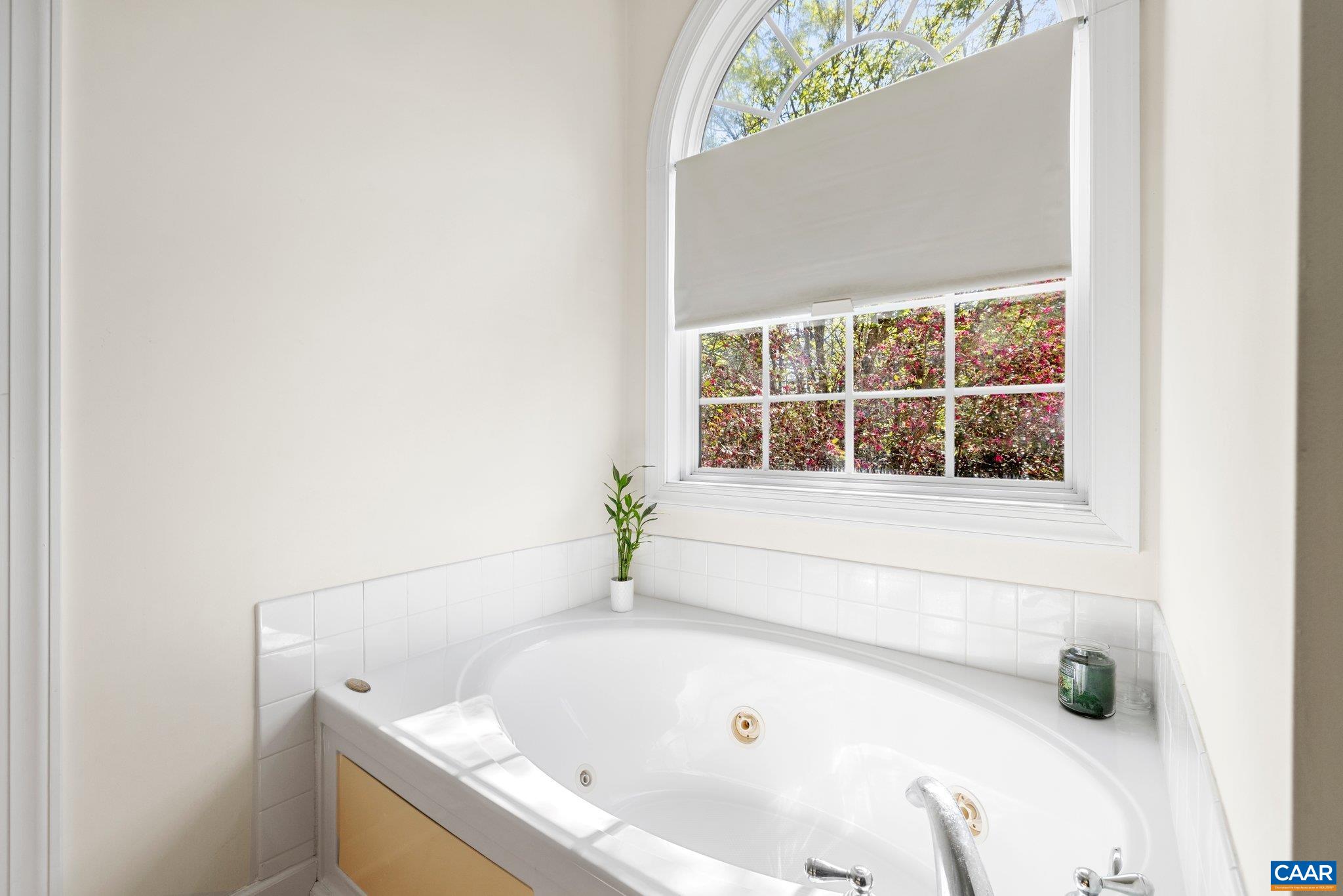 5437 3 Notch Road Louisa, VA 23093 - Photo 24 of 35 a white bath tub sitting in a bathroom next to a window