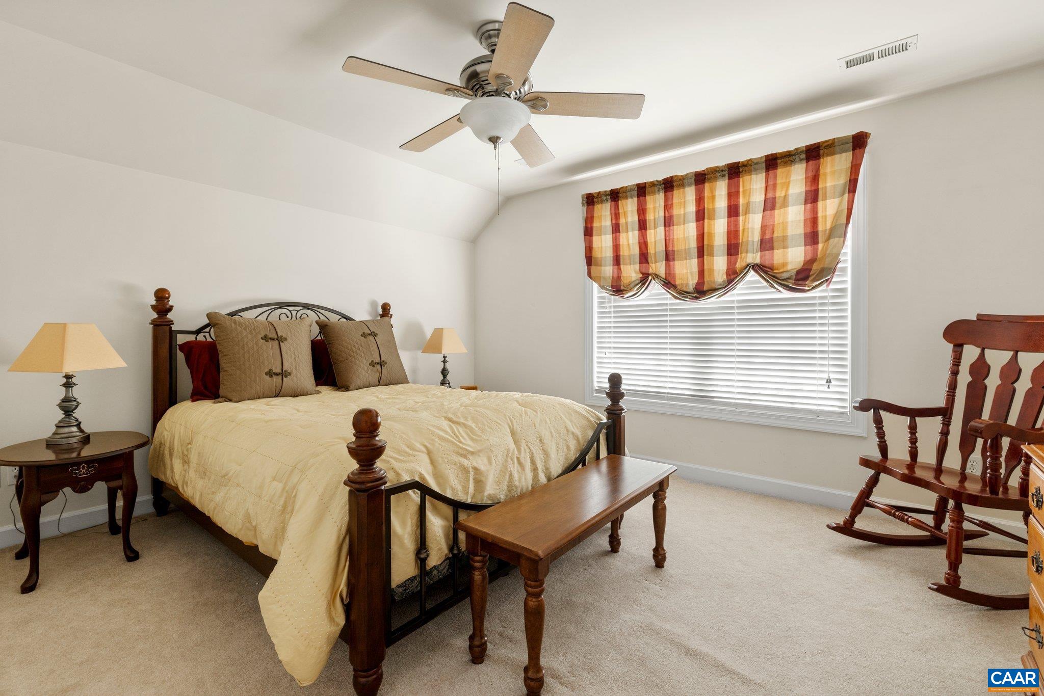 5437 3 Notch Road Louisa, VA 23093 - Photo 30 of 35 a bedroom with a bed a chair and a large window
