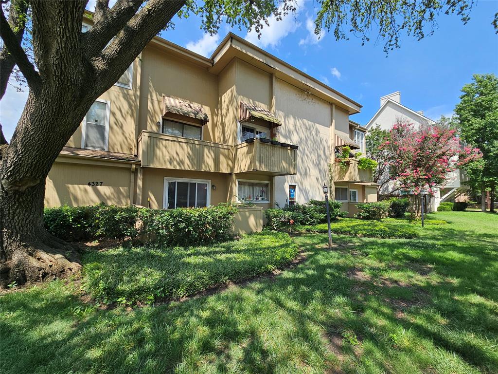 4327 Holland Avenue, Unit 102 Dallas, TX 75219 - Photo 1 of 20 a front view of a residential apartment building with a yard